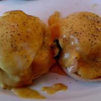 Eggs Benedict · Poached eggs and Canadian bacon on an English muffin, topped with hollandaise sauce and home...