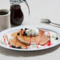 Blueberry Pancakes · Our original recipe buttermilk pancakes with blueberries topped with whipped cream. Served w...