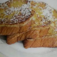 French Toast Slices · Slices of our egg bread dipped in egg batter and grilled to perfection. Served with syrup an...