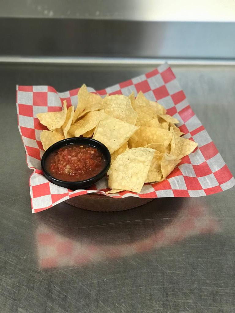Chips and Salsa · With our homemade queso con carne.