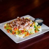 Smoked Turkey Salad · Sliced smoked turkey on chilled mixed greens with cheddar cheese, diced tomatoes, hickory-sm...