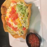 Taco Salad · Freshly fried flour tortilla bowl filled with beans, seasoned beef, lettuce, Monterey Jack a...