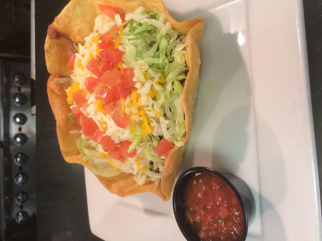 Taco Salad · Freshly fried flour tortilla bowl filled with beans, seasoned beef, lettuce, Monterey Jack and cheddar cheeses and tomatoes. Served with salsa on the side.   Make it the Ultimate! Add Rice, Queso, Jalapenos & Sour Cream $2