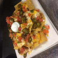 Macho Nachos · Crispy tortilla chips covered with queso con carne, melted Monterey Jack and cheddar cheeses...