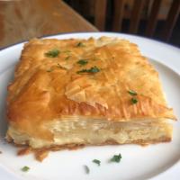 Tiropita · Cheese pie with feta and herbs baked in phyllo dough.