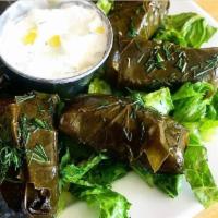 Dolmandes · Stuffed grape leaves with rice, herbs and spices.
