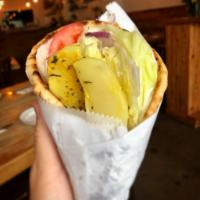 Vegetarian Souvlaki Sandwich · Baked home style lemon potatoes in a pita topped with lettuce, tomato, red onion and tzatziki.
