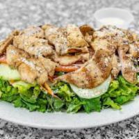 Grilled Chicken Caesar Salad · Grilled chicken, romaine lettuce, tomatoes, cucumbers, onions, croutons & creamy dressing.