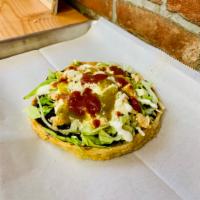 Sopes · Flattened corn dough. Topped with black beans,lettuce, sour cream and cheese. Salsa on side.