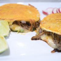 Mulitas · 2 corn tortillas, cheese, birria, onions, cilantro.