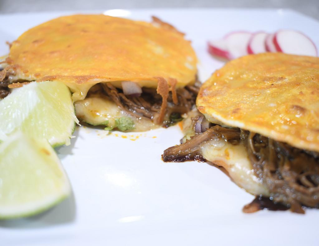 Mulitas · 2 corn tortillas, cheese, birria, onions, cilantro.