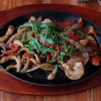 Shrimp Fajitas Chaparro · Sauteed shrimp, mixed peppers, onions, cooked in soy sauce. Served with rice and beans and f...