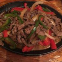 Steak Fajitas Chapparo · Sauteed steak, mixed peppers, onions, cooked in soy sauce. Served with rice and beans and fl...