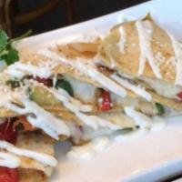 Ranchera Quesadilla · Flour tortilla with grilled steak, red, green pepper mix, onions and melted mozzarella chees...
