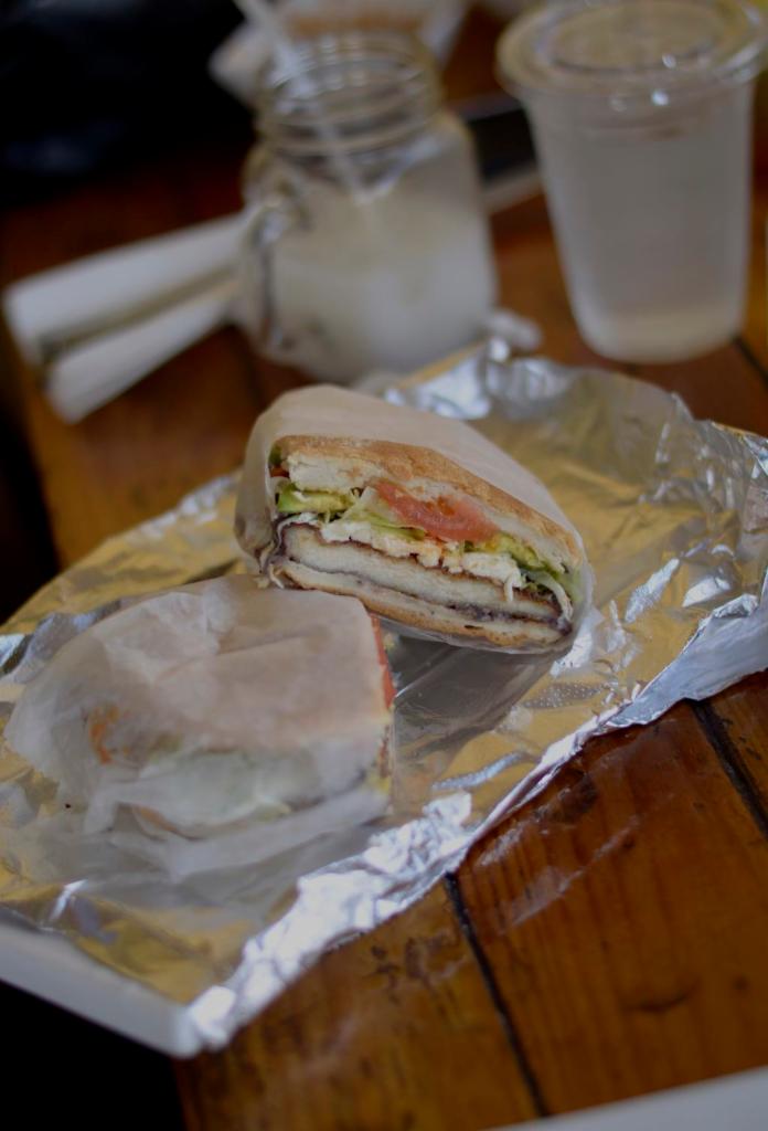 Torta de Carnitas · Shredded pork served in torta bread (Mexican sandwich bread) with mayonnaise, avocado, black beans puree, lettuce, tomatoes and Oaxaca cheese.