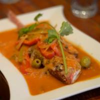 Branzino  · Whole Branzino cooked in light fresh tomato sauce with white wine, onions, peppers, olives a...