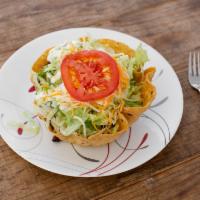 Taco Salad · Includes lettuce, beans, rice, tomato, cheese, sour cream and avocado sauce.