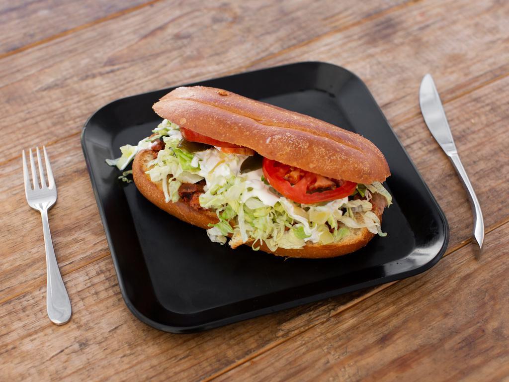 Torta · Served with onions, tomato, jalapenos, refried beans, sour cream and avocado.