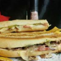 Cuban Sandwich · Fresh Cuban bread, pork roast, ham, Swiss cheese, mustard, and pickles.