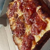 Detroit Style · Pan pizza, rectangular, crispy caramelized cheese on the crust, topped with our homemade rus...