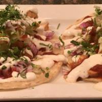 2 Grilled Skirt Steak Tacos  · Onion, cilantro, lettuce & crema