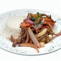 Lomo Saltado  · Steak sauteed with onions, tomatoes, and soy sauce with french fries and white rice.