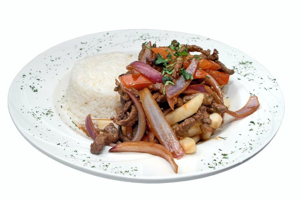 Lomo Saltado  · Steak sauteed with onions, tomatoes, and soy sauce with french fries and white rice.