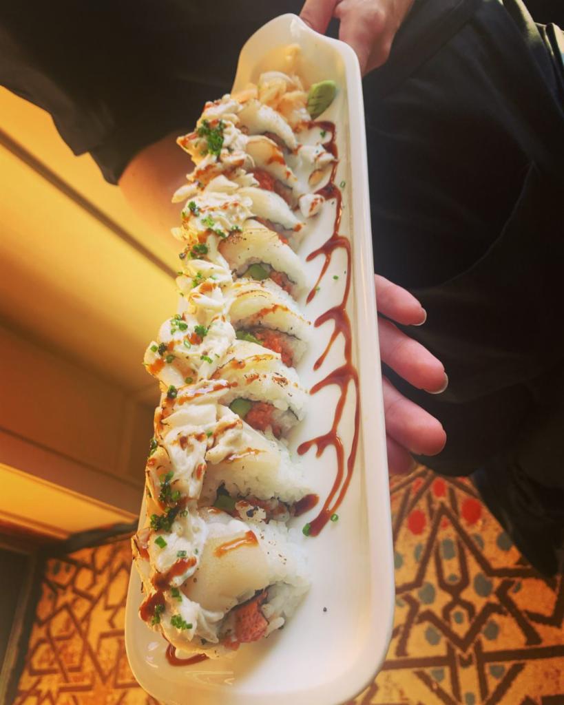 Twisted Scallop Roll · Spicy tuna or tempura shrimp , avocado, seared scallop, yuzu crab salad, scallions, eel sauce.