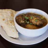 Curry Chicken · Served with rice, roti or dhall puri. 