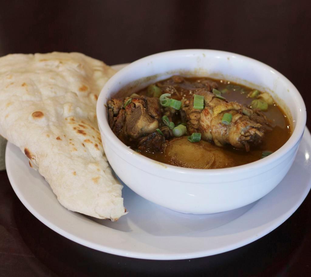 Curry Chicken · Served with rice, roti or dhall puri. 