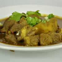Curry Lamb · Served with rice, roti or dhall puri. 