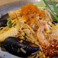 T1. The Best Pad Thai · Real authentic spicy Pad Thai with egg, shrimps, squids, mussels, crab, tobiko, shallot, rad...