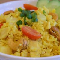 T15. Chicken Pineapple Fried Rice · Pineapple fried rice with egg, onion, green onion, tomato, turmeric and cashew nuts.