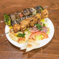 Mixed Grill Platter · 3 kebabs: chicken, lamb, & kofta chicken kebab with rice, salad, garlic/tahini sauce, & bread
