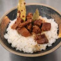 Chicken Adobo · Chicken breast marinated in a house adobo sauce and slowly simmered. Served on a bed of whit...