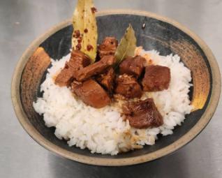 Chicken Adobo · Chicken breast marinated in a house adobo sauce and slowly simmered. Served on a bed of white rice.