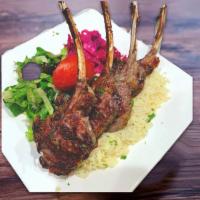 39. Lamb Chops  · 4 pieces. Char-grilled baby lamb chops served with rice and salad.