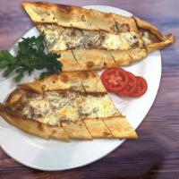 51. Ground Meat Pide · A flattened dough served with ground meat and mozzarella cheese with  melted butter on top.