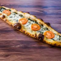 56. Spinach Pide · Flattened dough served spinach, onions, tomatoes and mozzerella cheese  with melted butter o...