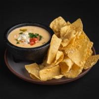 Chips and Queso · Bold, creamy, with just the right amount of kick – our hatch green chili queso is topped wit...