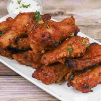 10 Piece BBQ Wings · Cooked wing of a chicken coated in sauce or seasoning.