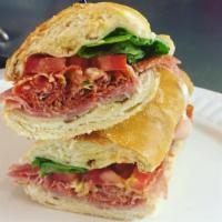 The Former Greatest Sandwich in the World · Salami, prosciutto, soppressata, onions, lettuce, fresh tomatoes and sundried tomato, provol...