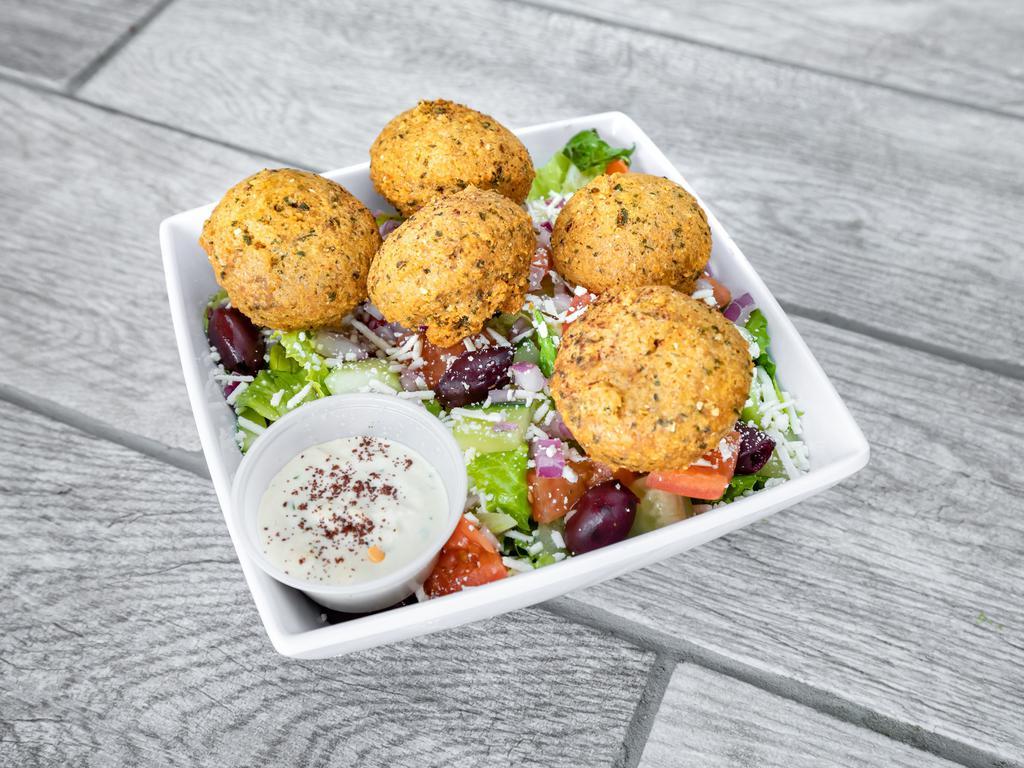 Falafel Salad · Our freshly made falafels on top of Greek salad. With a choice of our savory Sauces.