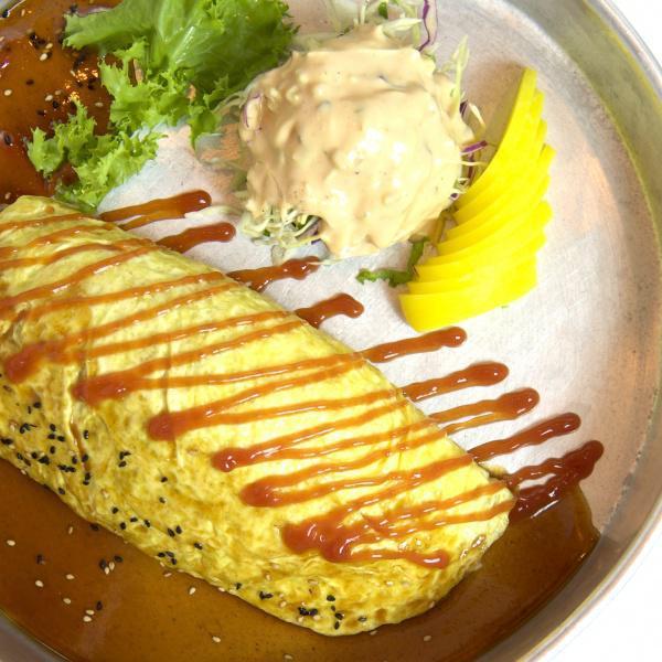 21. Omelet Rice · Fried rice with vegetables (onion, carrot) wrapped in eggs.Served with ketchup and Katsura sauce with cabbage salad and pickled radish