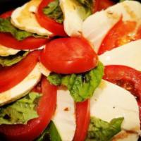 Caprese Salad · Our own made fresh mozzarella, sliced roma tomatoes, and fresh basil drizzled with olive oil...