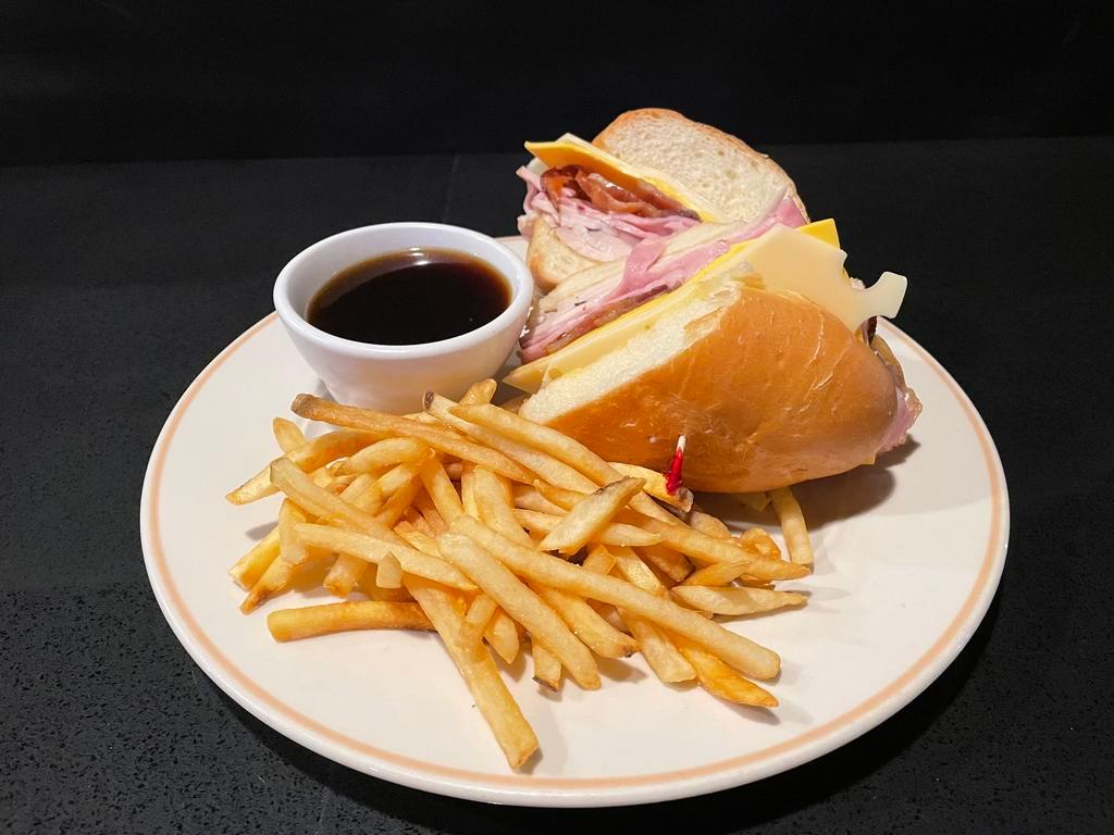 Club Dip Sandwich · Our popular club sandwich with turkey, ham, American and Seiss cheese, and bacon toasted on garlic French bread, served with au jus.