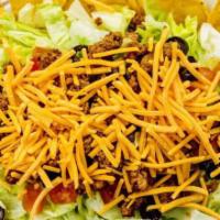 Taco Salad · Iceberg lettuce topped with seasoned ground beef, cheddar cheese, tomatoes, and black olives...