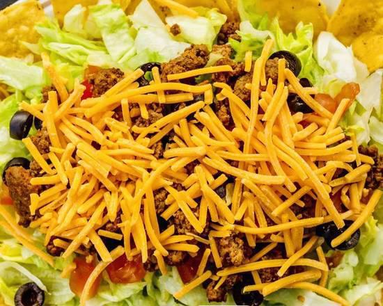 Taco Salad · Iceberg lettuce topped with seasoned ground beef, cheddar cheese, tomatoes, and black olives served with salsa, tortilla chips and the dressing of your choice. Gluten free.