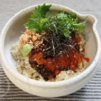 Ikura Don Buri · Salmon roe, seared salmon, baby arugula, nori seaweed, wasabi over brown sushi rice.