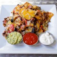 Chili Nachos · Fried corn tortilla chips topped with beef chili, pinto bean, monterrey and cheddar cheese, ...